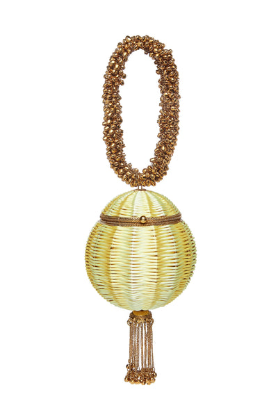 SHOP The Babi Beach Bracelet Clutch Bag from Mae Cassidy's SS21 'Poolside Glamour Collection'; https://maecassidy.com/ It’s playful hand woven lemon yellow detailing, reminisce a nostalgia for the 1950’s picnic style. Each piece is handmade by a skilled artisan from recyclable gold tone metalwork in a structured circular shape with bell detailing and a swishy chain tassel. Photography: Annie Lai, Set: Laura Little, MUA: Jinny Kim, Styling: Rubina Marchiori, Direction: Georgina Mae Lindsay