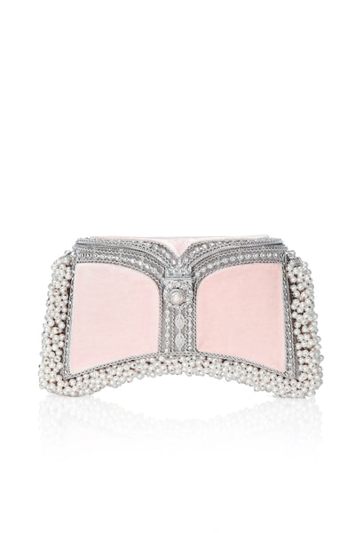 The Zeenat Pearl Purse Clutch Bag in Champagne Pink & Silver, from Mae Cassidy Capsule Collection An Evening In Paris. Each piece is handmade by a skilled artisan from recyclable silver-tone metalwork in a structured curved shape and Champagne Pink silk velvet panels. Embellished with shimmering crystals & over 1200 pearl detailing. Style it hand held or cross-body with it's detachable chain. It's the clutch you’ll always turn too to up the ante on any outfit.