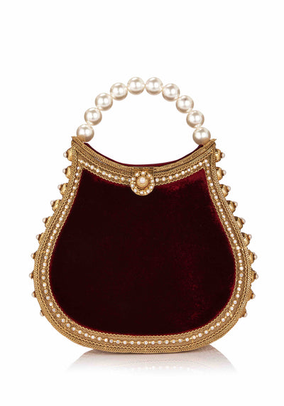 The Mae Cassidy Nimmi Pearl Purse Ruby Red handbag is back this season in a sumptuous new Ruby Red colour way. It's guaranteed to become the gem of your wardrobe.  Embellished with hand-placed, light catching sparkling crystals and oh-so-pretty detailing. Contrasted by plush ruby red Velvet panels. Slide your arm through it's elegant pearl top handle, to keep you hands free to step into cocktail hour. 
