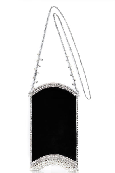 The Velvet Pearl Phone Bag in Cocktail Black and Silver, from Mae Cassidy's Capsule Collection An Evening In Paris. Style cross-body or over shoulder. It's the perfect size to fit all Iphone Plus styles, a small cardholder, keys, lipstick, and other small essentials. Each piece is handmade by a skilled artisan from recyclable silver-tone metalwork in a structured curved shape with black velvet panels. Embellished with shimmering crystals over 200 pearl detailing & handmade chain. Mae Cassidy 
